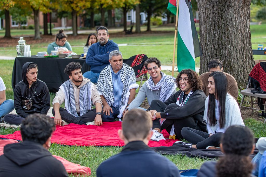 Students and faculty talking at the Olive Harvest Festival