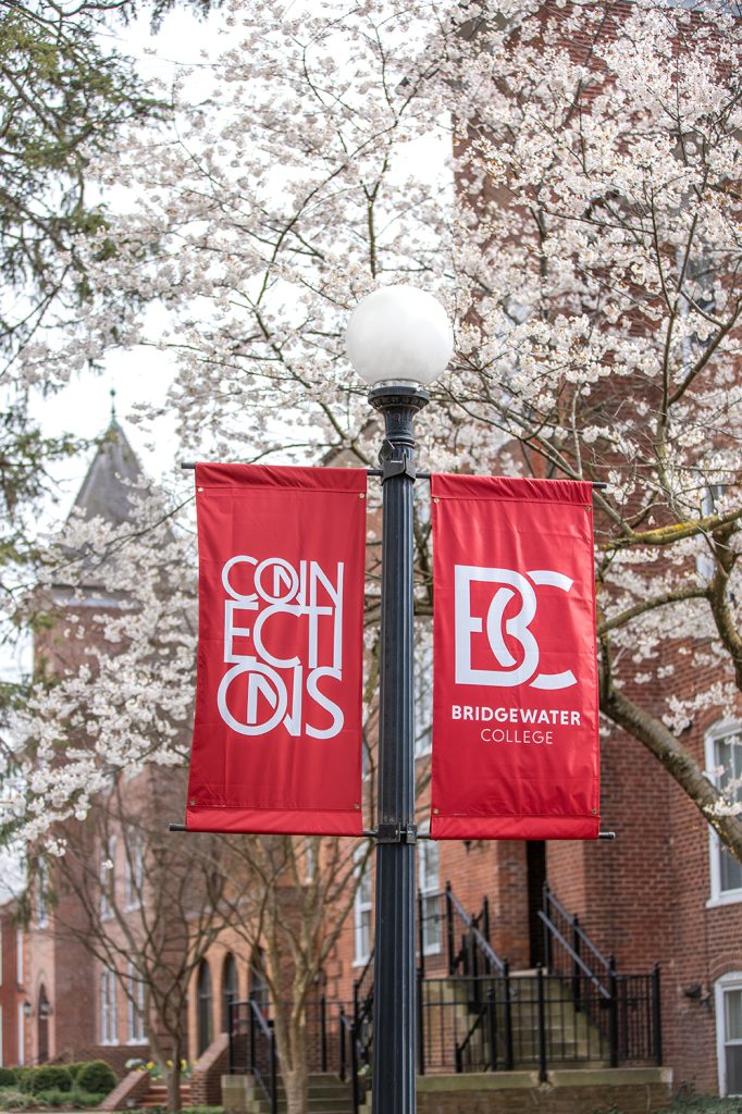BC Bridgewater College and Connections campaign banners on campus in front of flowering tree